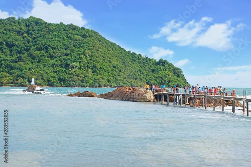 CHANTHABURI  THAILAND-26 JULY 2019  travelers on the wooden bridge path to Chedi Hua Laem pagoda on rock in the sea