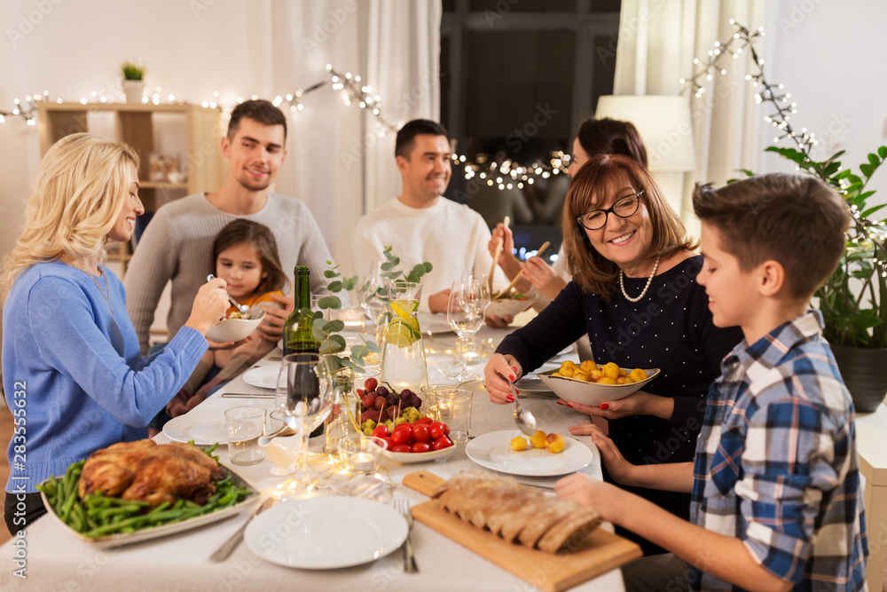 celebration, holidays and people concept - happy family having dinner party at home