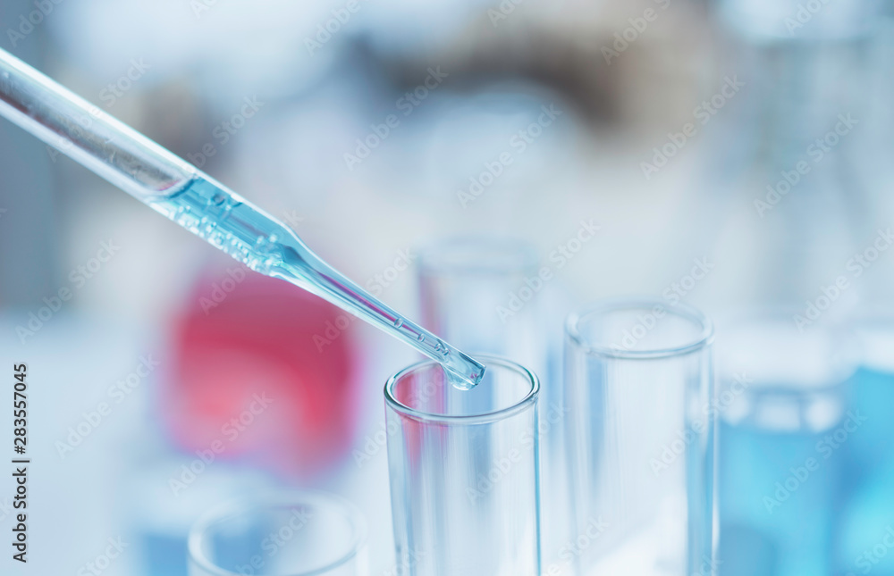 Researcher with glass laboratory chemical test tubes with liquid for analytical , medical, pharmaceutical and scientific research concept. Researcher with glass laboratory chemical test tubes with liquid for analytical , medical, pharmaceutical and scientific research concept.