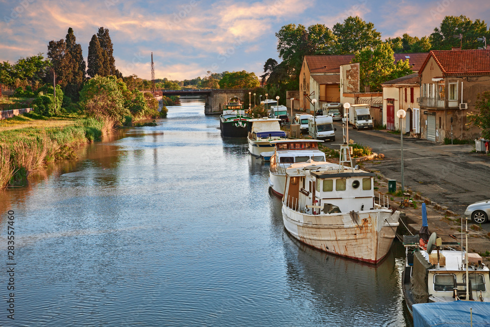 Saint-Gilles, Gard, Occitanie, France: waterway with boats in the town at the edge of the Camargue