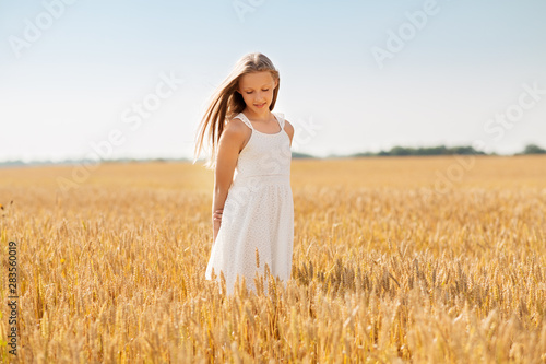 nature, harvest and people concept - smiling young girl on cereal field in summer © Syda Productions