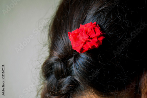picture of girl wearing red rose in her hairs