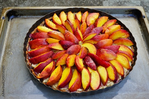 Homemade vegan fruit tart with nectarines and frangipane almond cream photo