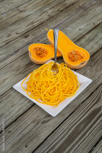Top view of healthy butternut squash noodles with fork stuck in pasta