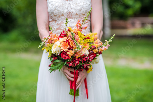  boho wedding bouquet made of red and yellow mixed flowers