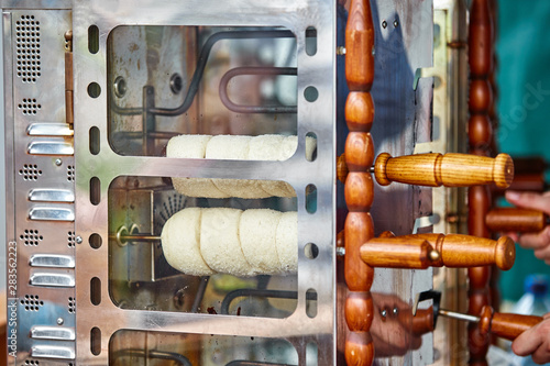 Trdelnik is street food of Prague. Three types of trdelnik with different sprinkling are ready to eat photo