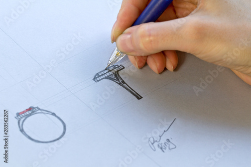 Drawing Jewelry Design. Artist designer drawing sketch jewelry on paper . Hand made.