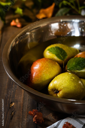 Organic pears in a large bowl of water