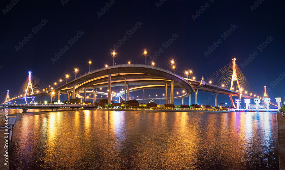 Obraz premium The Bhumibol Bridge, also known as the Industrial Ring Road Bridge. The bridge crosses the Chao Phraya River twice with two striking cable-stayed spans supported by two diamond-shaped pylons. Panorama