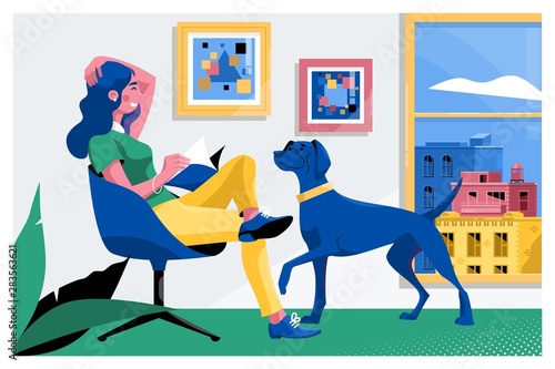 Girl reading a book and dog sitting on the armchair