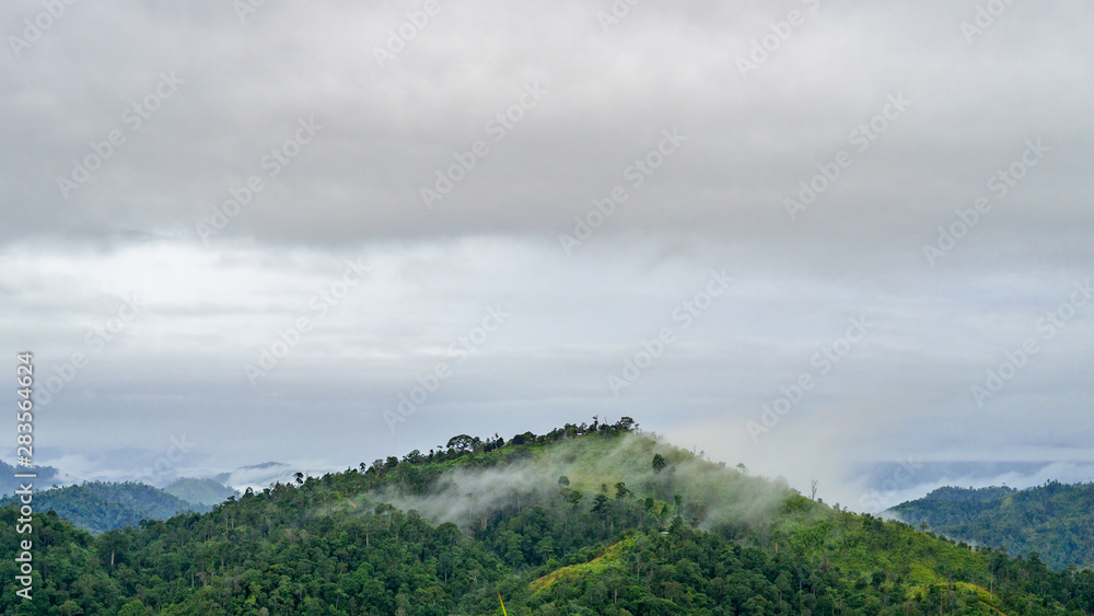 High mountains with fog covered in tropical rain forest, Thailand, Ratchaburi