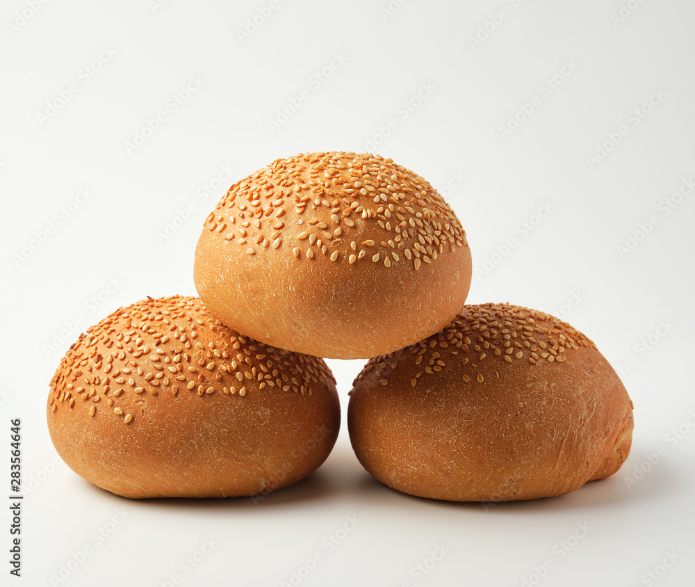 stack of baked whole round bun with sesame seeds stack of baked whole round bun with sesame seeds