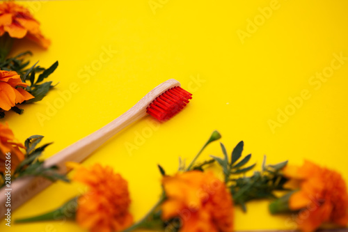 Eco bamboo toothbrush  organic on a yellow background  colored bristles  top view  top view. The concept of nature  environment  zero  zero plastic  a place for text.