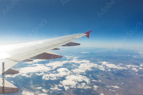 Wing of an airplane. Traveling concept. Aircraft wing on the clouds