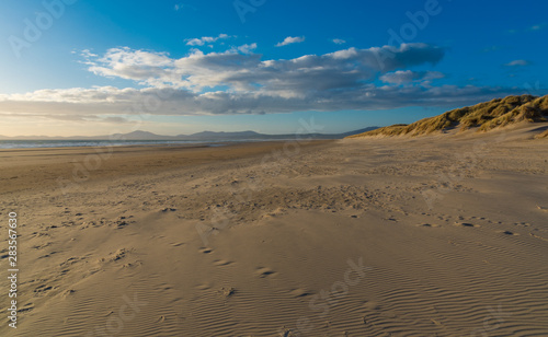 Views along the beach with sand dunes and mountains in the distance, Harlech, North Wales