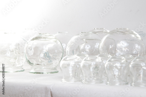 Bańki chińskie, szklane na białym stole na białym tle.