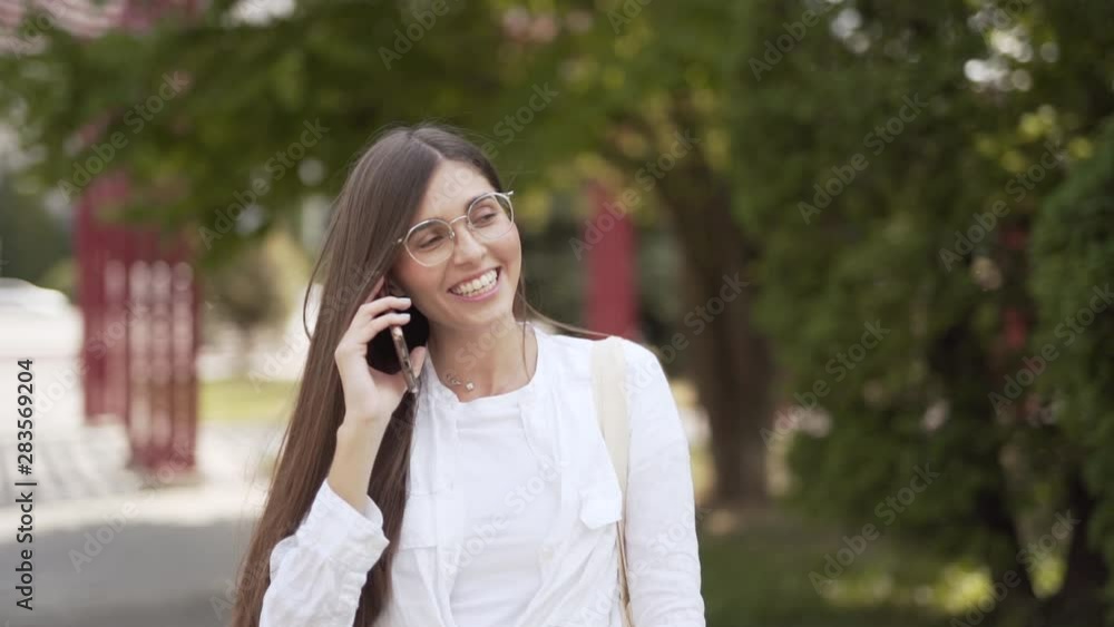 Attractive young woman talking laughing and flirting on the phone Attractive young woman talking laughing and flirting on the phone
