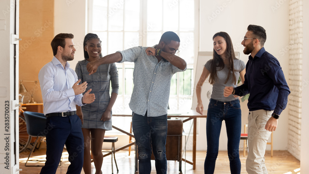 Happy funny black businesswoman with diverse team enjoy victory dance Happy funny black businesswoman with diverse team enjoy victory dance