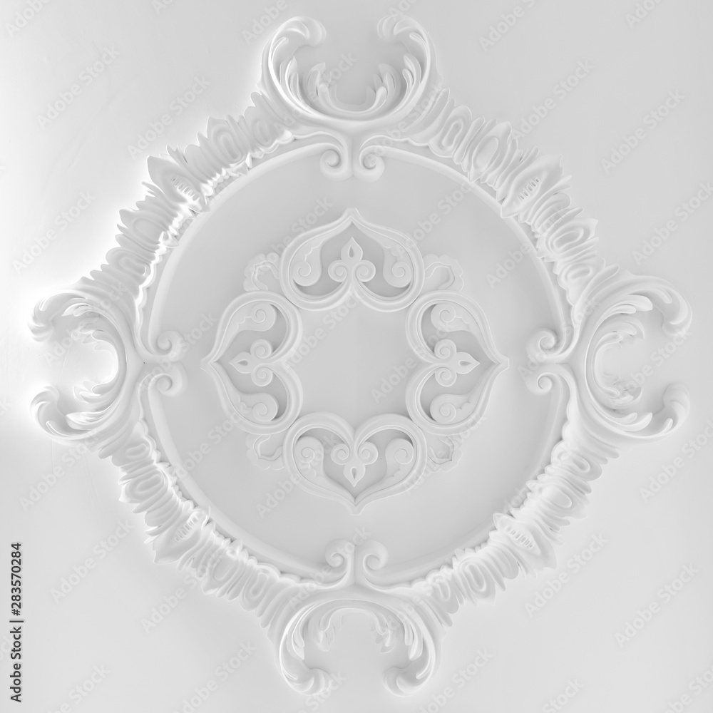 Decorative item made of white plaster on ceiling and wall. Beautiful ornament and relief stucco interior Decorative item made of white plaster on ceiling and wall. Beautiful ornament and relief stucco interior