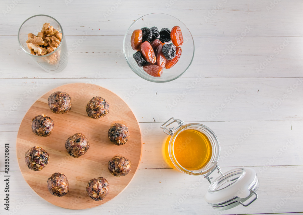 vegetarian food, energy balls of walnuts, dates, prunes, cranberries and honey vegetarian food, energy balls of walnuts, dates, prunes, cranberries and honey