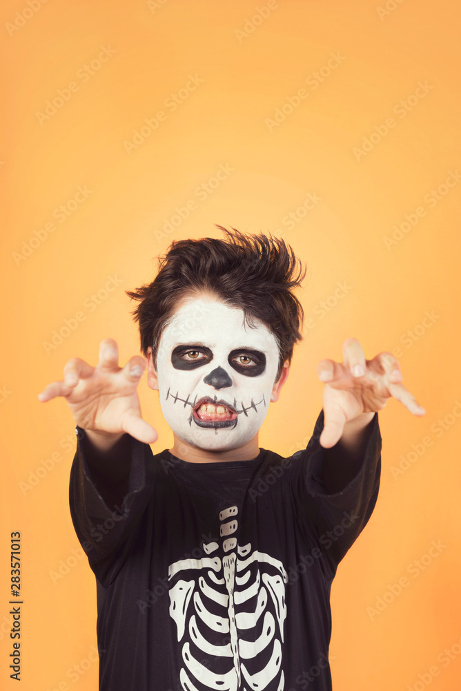 Happy Halloween. funny child in a skeleton costume of halloween Happy Halloween. funny child in a skeleton costume of halloween