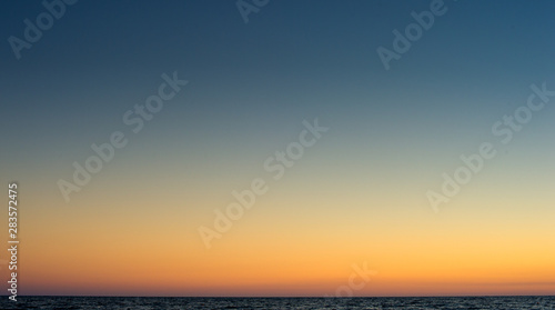 Relaxing beach background with clear sunset sky in the horizon with the sea © Iaroslav