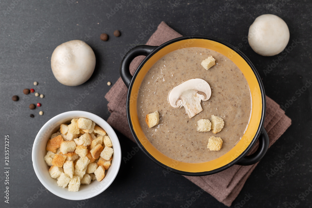 Champignon mushroom cream soup in a black bowl Champignon mushroom cream soup in a black bowl