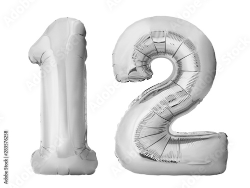Number 12 twelve made of silver inflatable balloons isolated on white background. Silver chrome helium balloons forming 12 twelve number