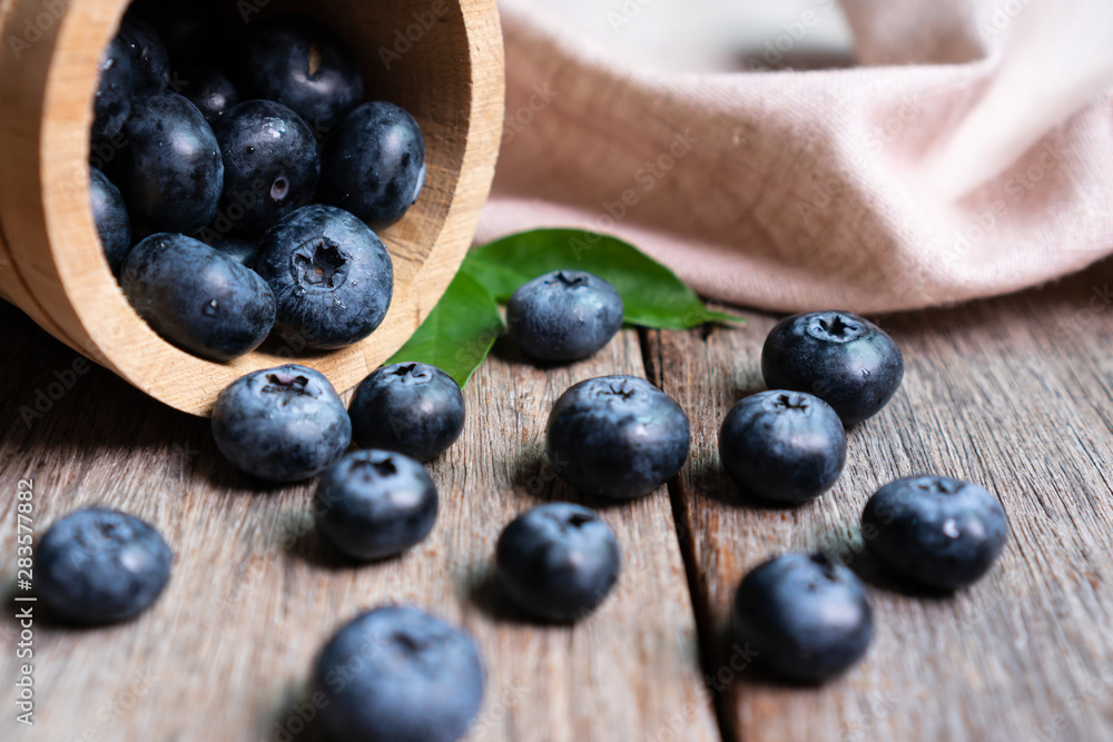 Freshly blueberries in wooden bucket Freshly blueberries in wooden bucket