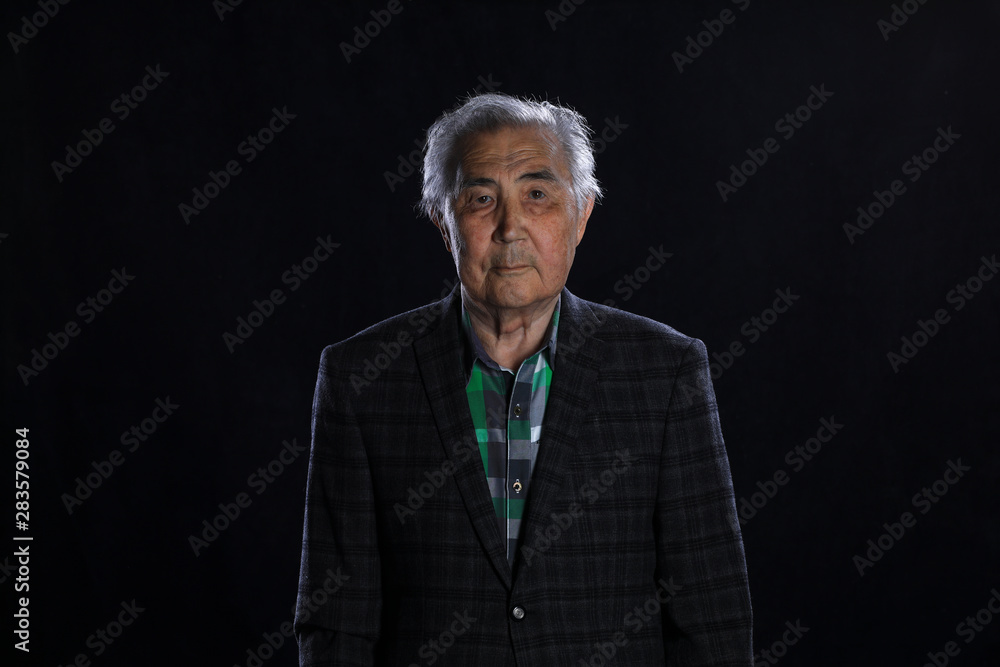 portrait of a 90 year old man on a black background portrait of a 90 year old man on a black background