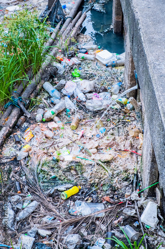 Ecology watercourse river canal with garbage and plastic