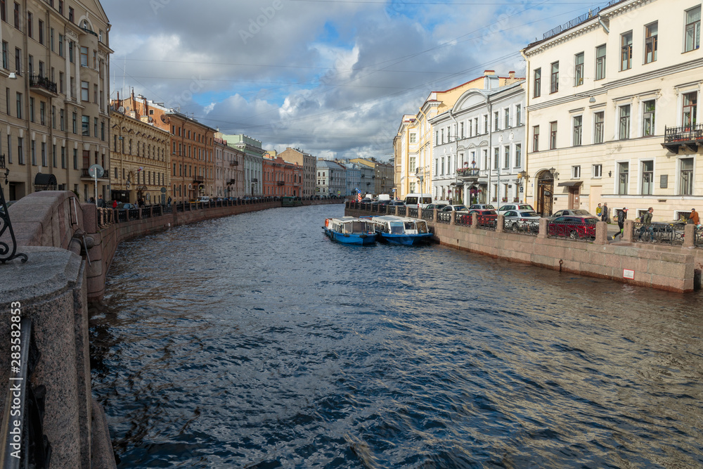 Moika river granite embankment in historic center of Saint-Petersburg, Russia. Urban summer landscape.