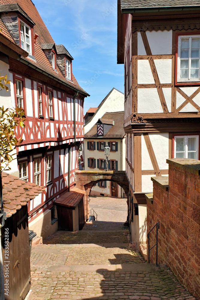 Narrow stepped street with traditional half timbered buildings in the town of Miltenberg, Bavaria, Germany