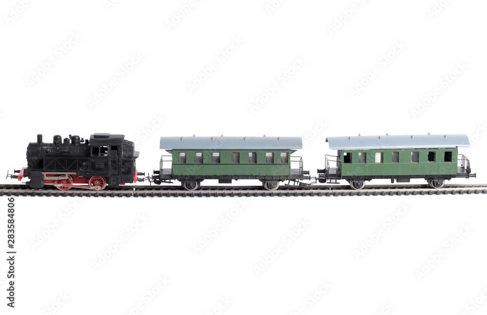 Obraz premium Model of a steam locomotive and passenger cars on rails on a white background