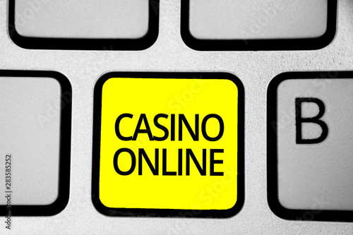 Handwriting text writing Casino Online. Concept meaning Computer Poker Game Gamble Royal Bet Lotto High Stakes Keyboard yellow key Intention create computer computing reflection document photo