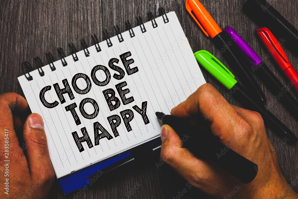 Word writing text Choose To Be Happy. Business concept for Decide being in a good mood smiley cheerful glad enjoy Hand holding pen and paper sketch words near lie some pen on woody desk Word writing text Choose To Be Happy. Business concept for Decide being in a good mood smiley cheerful glad enjoy Hand holding pen and paper sketch words near lie some pen on woody desk