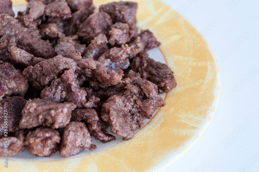 Close-up shoot of home cook fresh meat on plate with white background Close-up shoot of home cook fresh meat on plate with white background