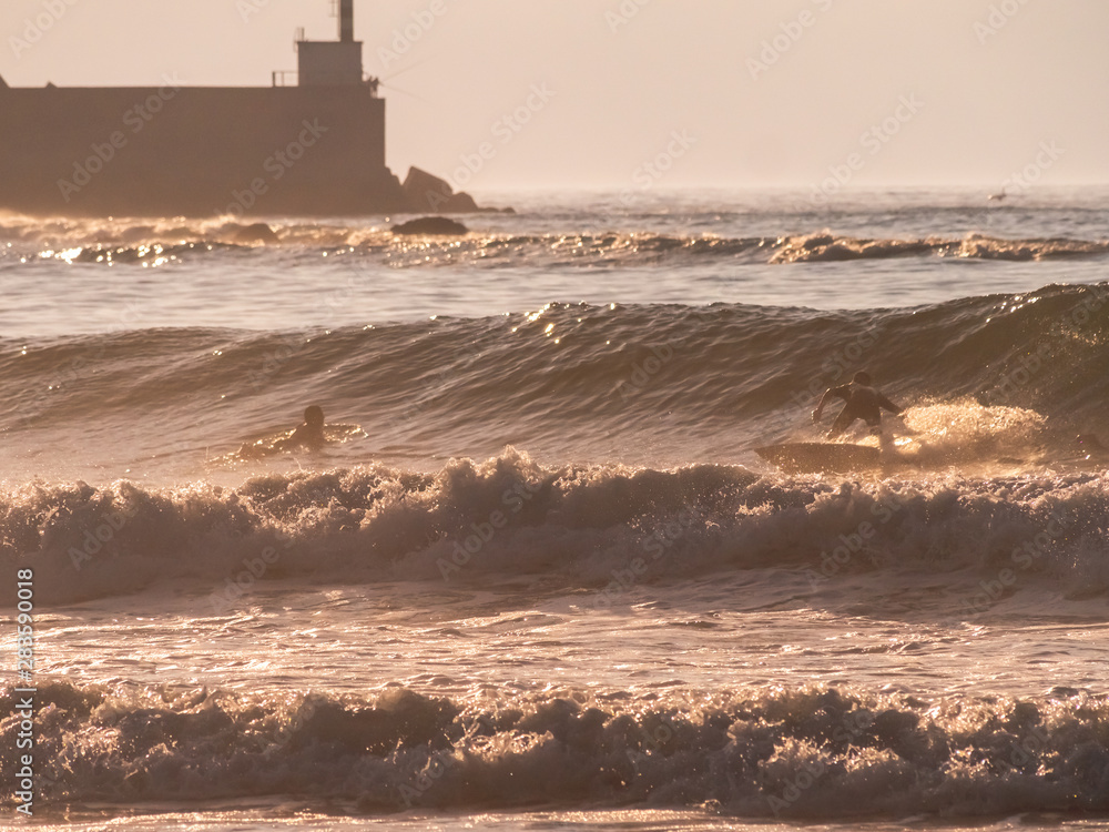 surfer enjoying waves at sunset