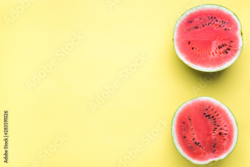 Colorful fruit minimal background of fresh watermelon slices on yellow background