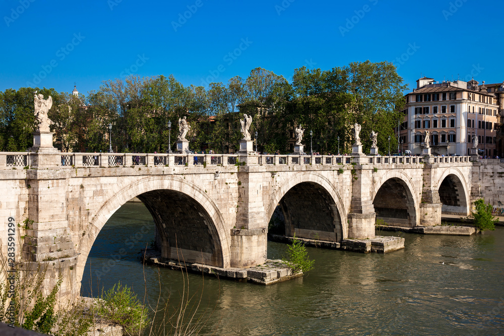 ROME, ITALY - APRIL, 2018: Sant Angelo Bridge over the Tiber River completed in 134 AD by the Emperor Hadrian