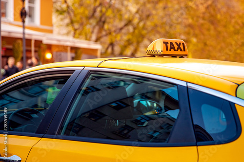 Yellow roof of taxi car, autumn weather. Concept service for travel