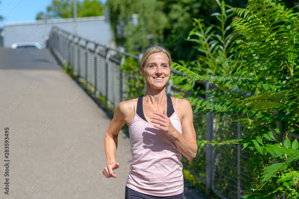 Determined woman smiling happy while jogging Determined woman smiling happy while jogging
