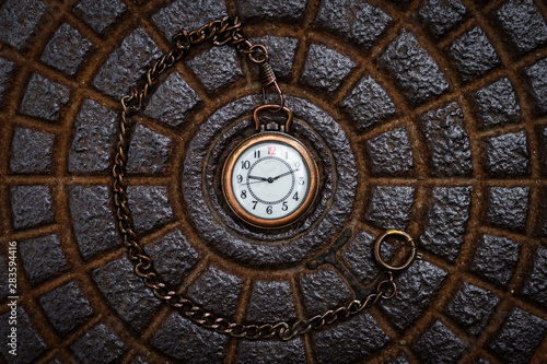 Pocket watch on metal texture background. Time concept