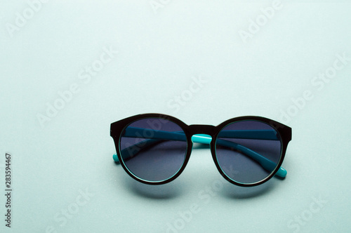 Stylish plastic dark sunglasses on colorful background. Eye care and diseases concept, eye protection.