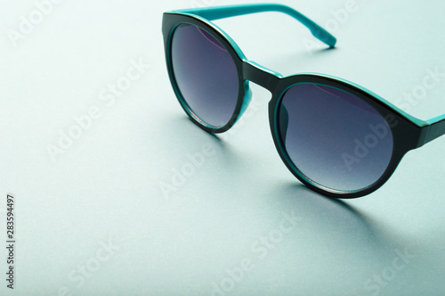 Stylish plastic dark sunglasses on colorful background. Eye care and diseases concept, eye protection.