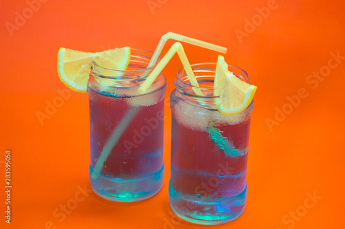 Two refreshing cocktails with lemon and straw photo