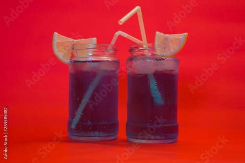 Two refreshing cocktails with lemon and straw photo