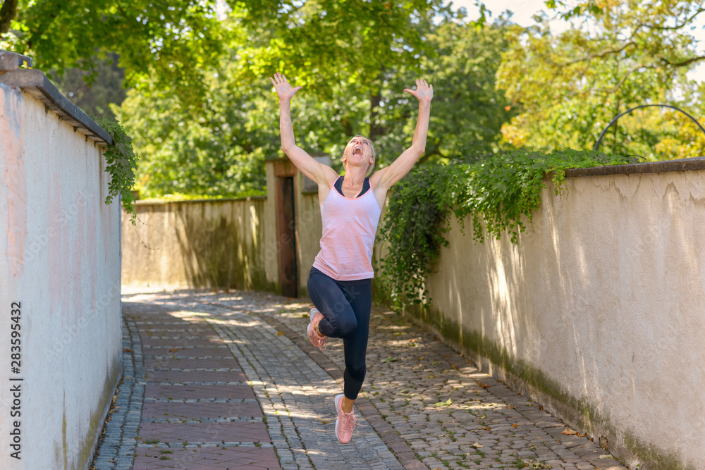 Happy woman celebrating leaping in the air