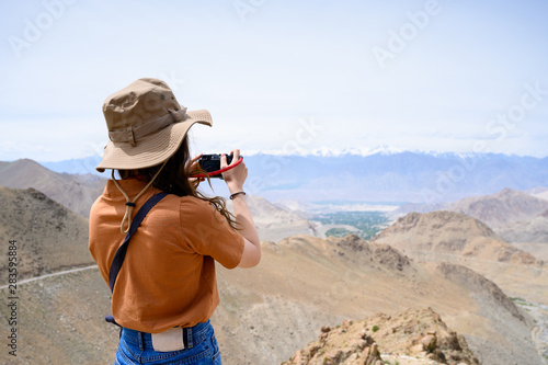 Photography Portrait of young Asian woman talking photos on snow mountain, outdoors and trav