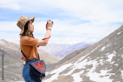 Photography Portrait of young Asian woman talking photos on snow mountain, outdoors and trav